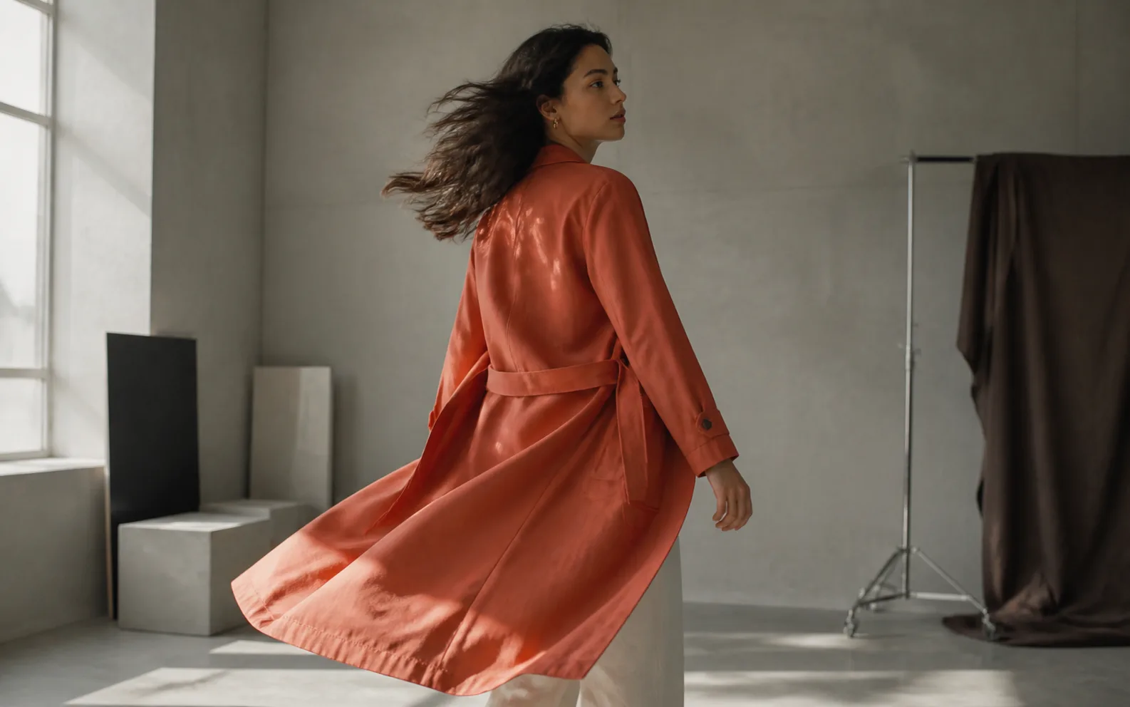 An editorial still with natural hair and fabric motion in a studio